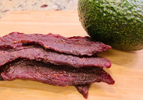Finished basic beef jerky stacked on a cutting board