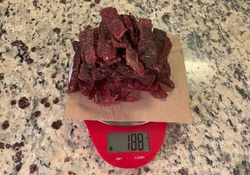 Finished beef jerky on a scale reading 188 grams