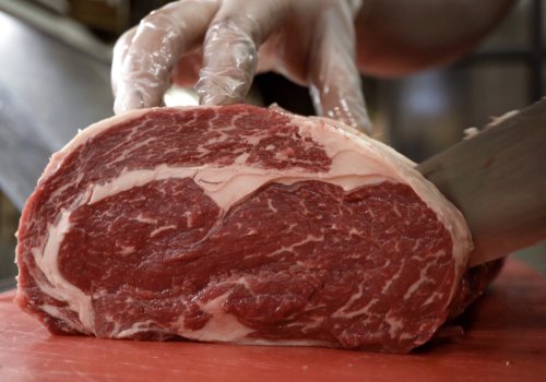 A heavily marbled beef roast being sliced