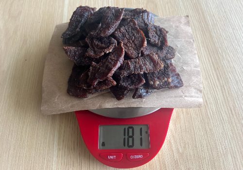 Finished jerky on a scale reading 181 grams