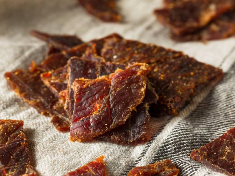 Dark jerky pieces scattered over a cloth