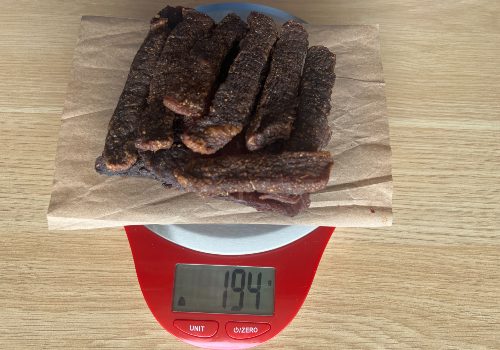 Cajun beef jerky on a scale reading 194 grams