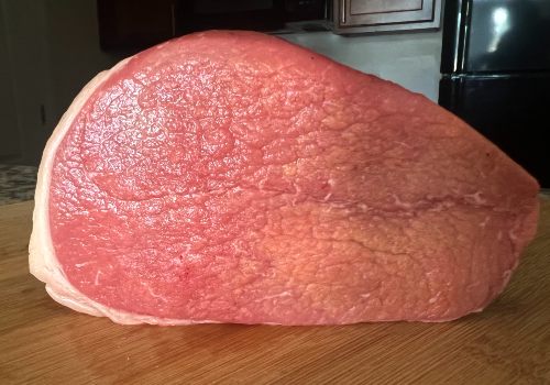 An eye of round roast before trimming
