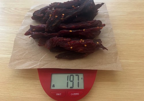 Finished chili garlic jerky on a scale reading 197 grams