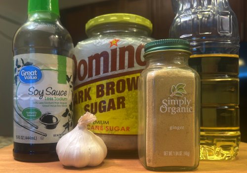 Soy sauce, brown sugar, ginger, garlic, and sesame oil on a counter