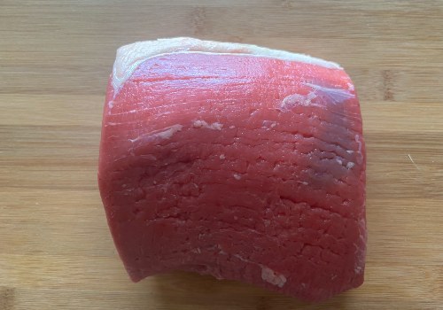 An eye of round roast on a wooden board