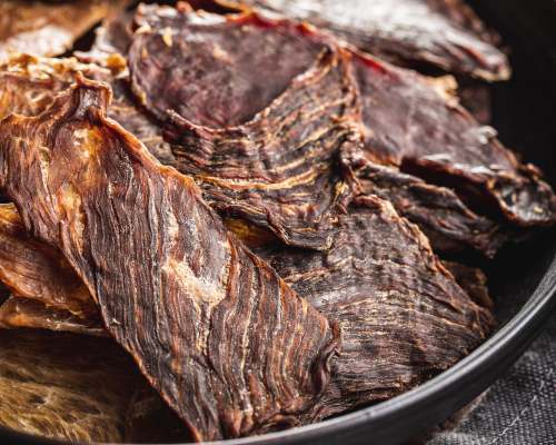 Thin dried beef slices piled in a dark bowl