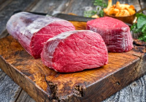A beef tenderloin with thick round slices cut from one end