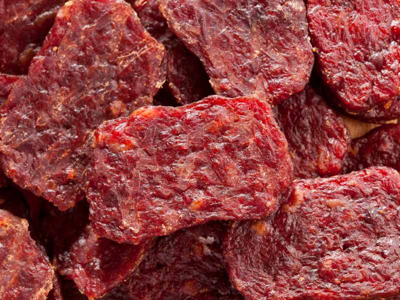 Close-up of small rectangular dried meat pieces