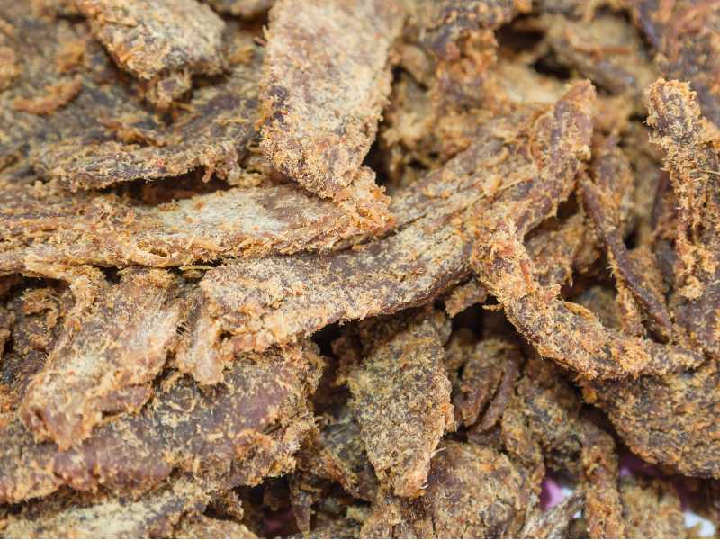 Dried meat pieces with a pale, powdery-looking surface coating
