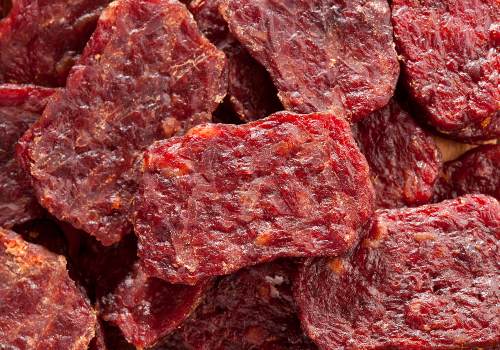 Close-up of reddish dried meat pieces