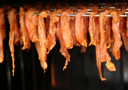 Seasoned meat strips suspended from a rack during drying