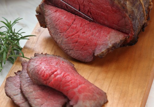 Cooked roast beef with slices showing the direction of its fibers