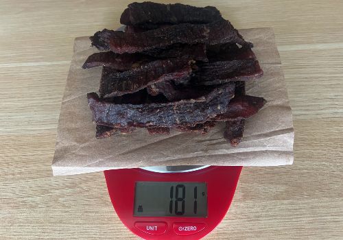 Finished jerky on a scale reading 181 grams