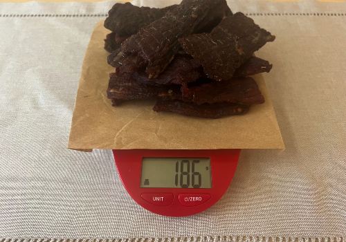 Finished jerky on a scale reading 186 grams