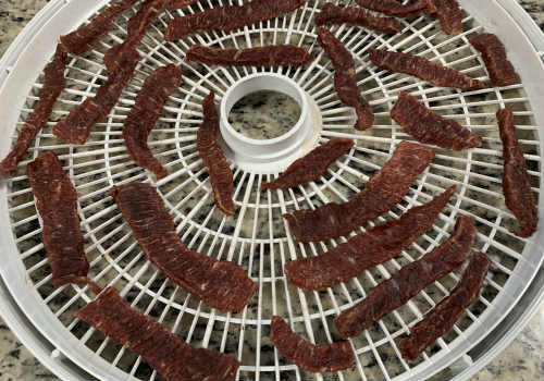 Dried original-style jerky strips on a round tray