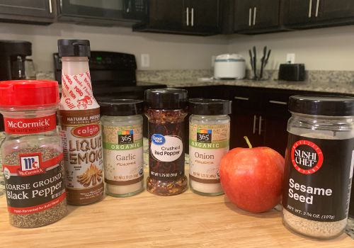 An apple, sesame seeds, garlic, onion, pepper, and liquid smoke