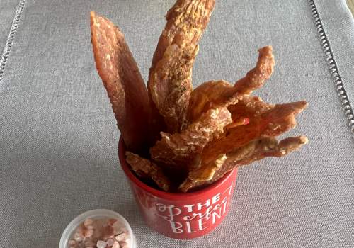 Jerky strips standing in a small red cup