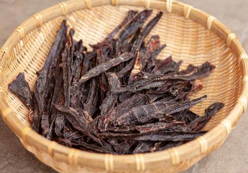 Narrow jerky strips in a shallow basket