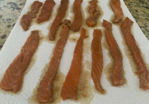 Long salmon strips resting separately on paper towels