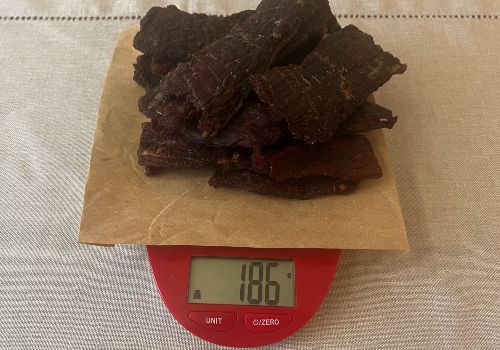 Finished smoky jerky on a scale reading 186 grams