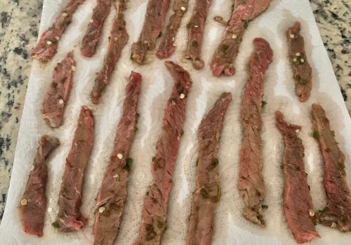 Long marinated beef strips laid on paper towels