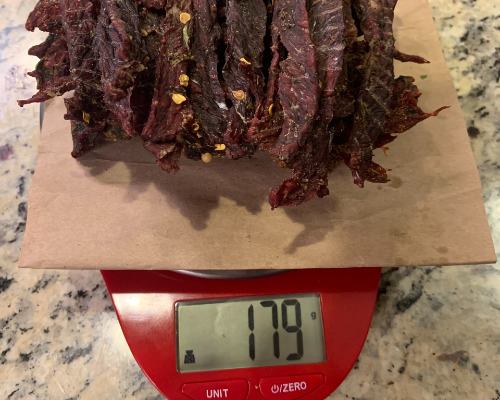 Finished jalapeno jerky on a scale reading 179 grams