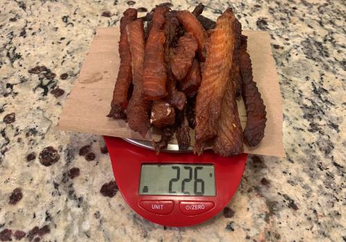 Finished salmon jerky on a scale reading 226 grams