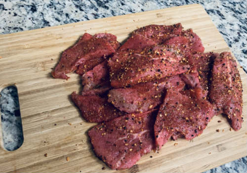 Raw beef slices covered with coarse dry seasoning