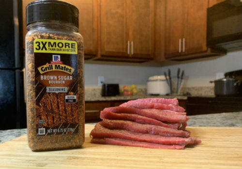 Sliced beef beside a jar of Grill Mates Brown Sugar Bourbon seasoning