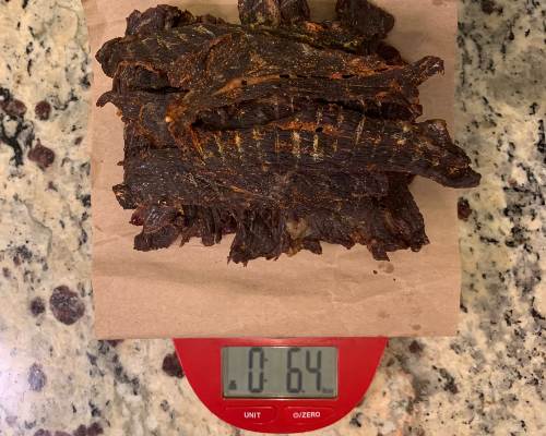 Finished jerky on a scale reading 6.4 ounces