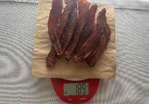 Finished turkey jerky on a scale reading 189 grams