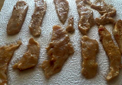 Marinated turkey strips laid out on paper towels