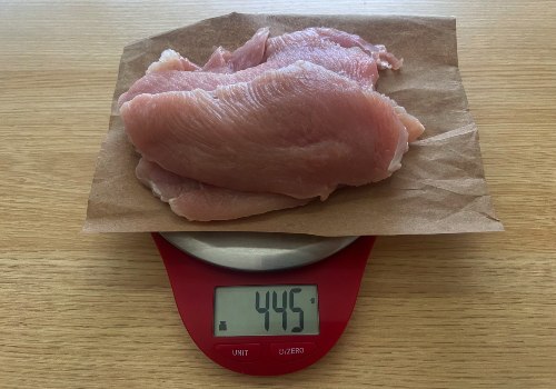 Raw turkey on a scale reading 445 grams