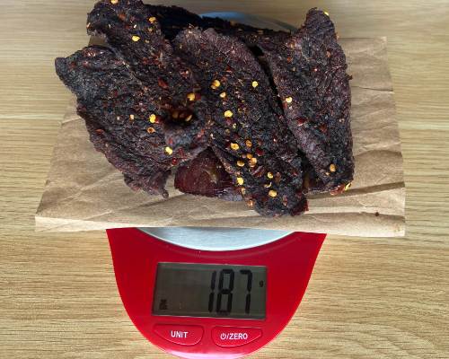 Finished jerky on a scale reading 187 grams